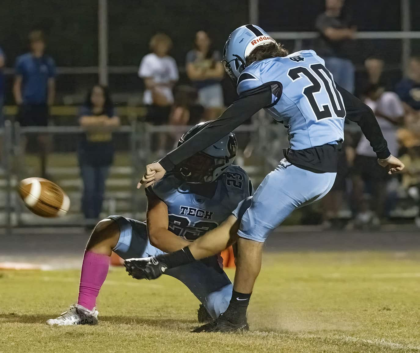 Nature Coast ,20, Caiden Mellecker punctuates a touchdown with the extra point out of the hold by ,23, Allan Ho. Photo by JOE DiCRISTOFALO