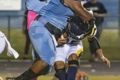 Nature Coast ,2, Christian Comer puts a halt to the progress of Land O’ Lakes , 25, Jaiden Gerena during the first half of Friday night’s contest. Photo by JOE DiCRISTOFALO