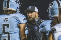 Nature Coast Head Coach Cory Johns discusses offensive strategy with his players during a time out during the game with Land O’ Lakes. Photo by JOE DiCRISTOFALO