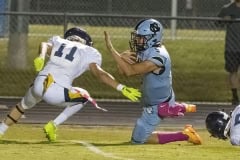 Nature Coast ,5, Jackson Hoyt gets tripped up after a gain against Land O’ Lakes early in Friday night’s contest. Photo by JOE DiCRISTOFALO