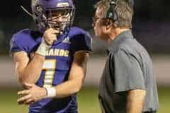 Hernando High, 7, James Belmont confers with Head Coach John Scargle between plays during the Homecoming game against Crystal River. Photo by JOE DiCRISTOFALO