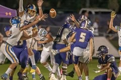 Hernando placekicker, 5, Jesse Faulks kicks an extra point despite the blocking attempt by Crystal River during the Homecoming game in Brooksville. The hold was by ,6, Emanuel Acker. Photo by JOE DiCRISTOFALO