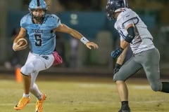 NCT QB, 5, Jackson Hoyt tries to elude a tackle by Central High ,11, Malachi Russell Friday at Nature Coast.  Photo by JOE DiCRISTOFALO