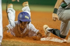 Hernando High’s Henry Robinson slides safely into third base Tuesday night in the home game versus Weeki Wachee. Photo by JOE DiCRISTOFALO