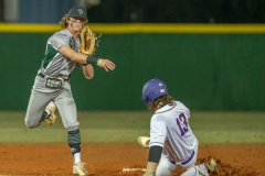Weeki Wachee shortstop Jayden Vigo attempts to turn a double play after forcing out Hernando High’s ,13,Henry Robinson Tuesday in Brooksville. Photo by JOE DiCRISTOFALO
