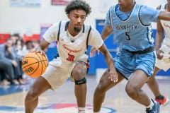 Springstead High, 3, Divine Torain, tries to drive past the defense by Berkeley Prep, 5, Damien Henderson  Wednesday 12/21/2022  in the 8th Annual Greg O’Connell Shootout at Springstead High.  Photo by JOE DiCRISTOFALO