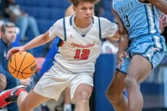 Springstead High,12, Austin Nicholson drives past Berkeley Prep, 3, George Kimble  Wednesday 12/21/2022 in the 8th Annual Greg O’Connell Shootout at Springstead High.  Photo by JOE DiCRISTOFALO