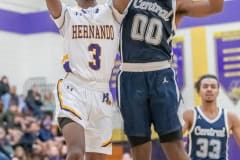 Hernando High, 3, Josiah Wright tries a shot  against the defense by Central High, 00, Tylor Daniel Tuesday 1/17/23 in Brooksville. Photo by JOE DiCRISTOFALO