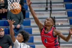 Central High, 00, Tylor Daniel underhands a layup while defensed by Springstead High’s Caidell Gilbert, 4, Friday night at Central High.  Photo by JOE DiCRISTOFALO