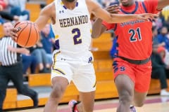 Hernando High ,2, R.J. Wilson advances the ball past Springstead ,21, Martez Archibald Tuesday 1/3/23 at Hernando High. Photo by JOE DiCRISTOFALO