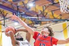 Hernando High ,2, R.J. Wilson elevates to put up a shot while defended by  Springstead ,2, Quinn Lenamon Tuesday 1/3/23 at Hernando High. Photo by JOE DiCRISTOFALO