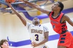 Hernando High, 10, Michael Saavareseshoots over Springstead high, 20, Andrew Danchese. Photo by JOE DiCRISTOFALO