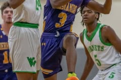 Hernando High, 3, Josiah Wright looks for a path to the basket guarded ty Weeki Wachee, 24, Anthony Wilson Tuesday night at Weeki Wachee High. Photo by JOE DiCRISTOFALO