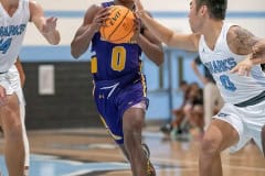 Hernando High, 0, Liandre Wright drives to the basket between NCT, 14, Canyon Anderson and, 0, Allan Ho during the match Tuesday at Nature Coast.  Photo by JOE DiCRISTOFALO