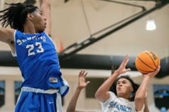 Nature Coast’s ,3, Luke Sanders tries to negotiate room for a shot in the middle of the Sebring High defense Thursday in the Final Game of the Nature Coast Christmas Tournament. Photo by JOE DiCRISTOFALO