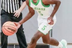 Weekie Wachee #5 Senior Quinton Hines takes ball down the court against Gulf High School in Thursday nights game. Photo by Cheryl Clanton.