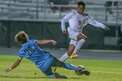 Springstead High’s ,9, Alden Haynes has his progress thwarted by a sliding tackle by NCT, 20, Ryan DiFrank at  Nature Coast Friday. Photo by JOE DiCRISTOFALO