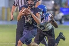 Central High, 14, Braden Joyner attempts to escape the pursuit of Anclote High’s ,5, Damien Spencer. Photo by JOE DiCRISTOFALO