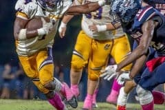 Hernando High’s Leandre Wright, 4, stiff arms a Springstead tackler, 1, Cordarius Owens on the way to a first down in Friday night’s Burger Bowl. Photo by Joe DiCristofalo.
