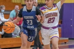 Central High, 23, Qui’mya Thomas works to advance the ball up court past the defense by Hernando High, 23, Jessenya Jimenez Friday 1/6/23 at Hernando High. Photo by JOE DiCRISTOFALO