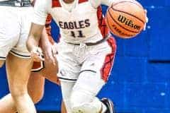 Eagles 11 Jr. Samantha Suarez breaks away from the swarm of Warhawks during Tuesday night's game and runs for a shot.  Photo by Cheryl Clanton.