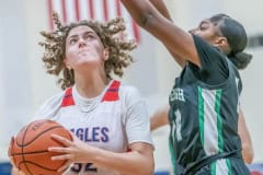 Springstead , 32, Addy Osborne works under the basket to get a shot against Gulf High’s ,14, Ania Butler Wednesday in the Springstead Holiday Tournament. Photo by JOE DiCRISTOFALO