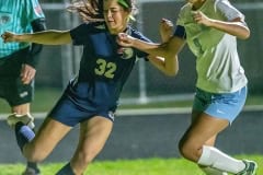 Springstead , 32, Sidney Anderson looks to cross a pass deep in the Offensive zone while defended by Nature Coast, 9, Ariana Wilson Friday Night at Springstead High.﻿ Photo by JOE DiCRISTOFALO.