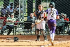 Sharks #9 Gianna Villari up and ready for ball as Leopard #3 Sr. Aryanna Eliopoulos runs into home. Photography by Santo.