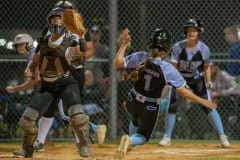 Weeki Wachee catcher Taylor Laviano waits for the ball as Nature Coast runner,1, Kamryn Baker scores Tuesday night in Brooksville. Photo by JOE DiCRISTOFALO