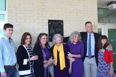 The family of Dr. Paul Farmer in front of the plaque commemorating his legacy at Hernando High School.