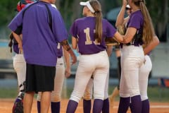 Hernando High Head Softball Coach, Kevin Bittinger, has a meeting on the mound after Trinity Catholic put runners into scoring position Wednesday at Tom Varn Park. Photo by JOE DiCRISTOFALO