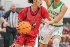 Springstead, 5, Xylus Pastrana drives to the basket while guarded by Weeki Wachee,11, Matthew Stumpf, Friday 12/9 at Weeki Wachee High School. Photo by JOE DiCRISTOFALO.