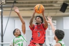 Springstead, 3, Divine Torain, rises above Weeki Wachee defenders, 24, Anthony Wilson and, 23, Steven Martin, Friday 12/9 at Weeki Wachee High School. Photo by JOE DiCRISTOFALO.