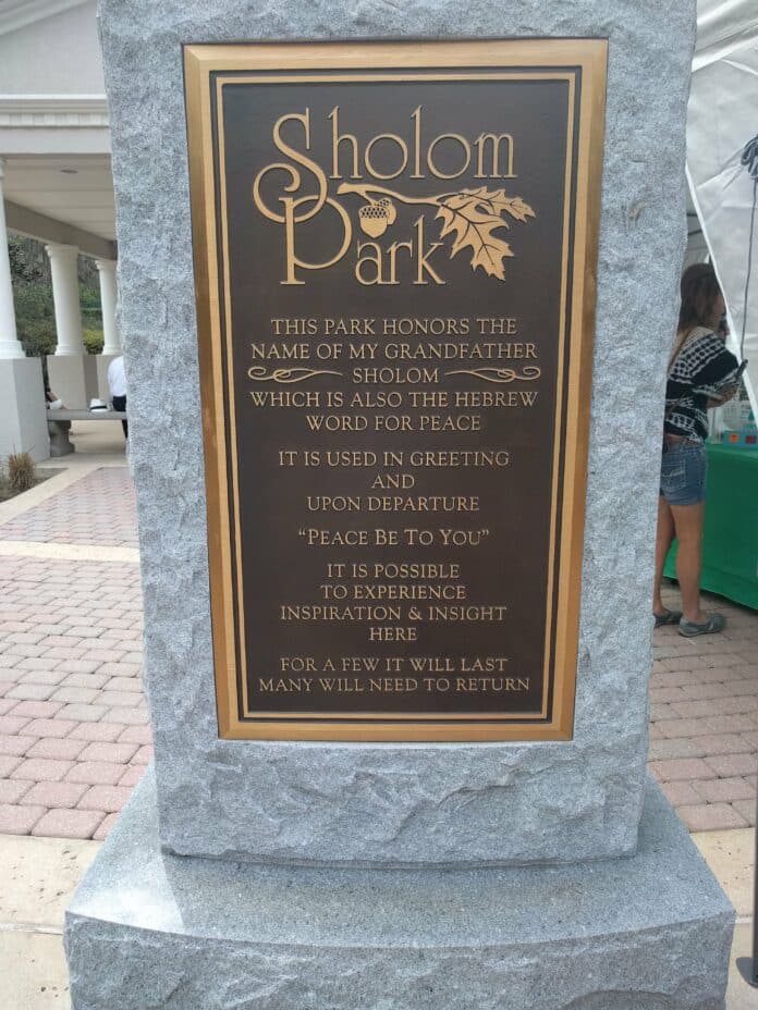 Plaque explaining how Sholom Park got its name