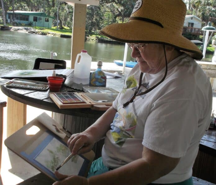 Judith McIntire painting in plein air at Mary's Fish Camp