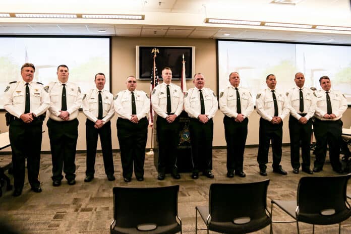 Sheriff Al Nienhuis, far left, with the nine new deputies.