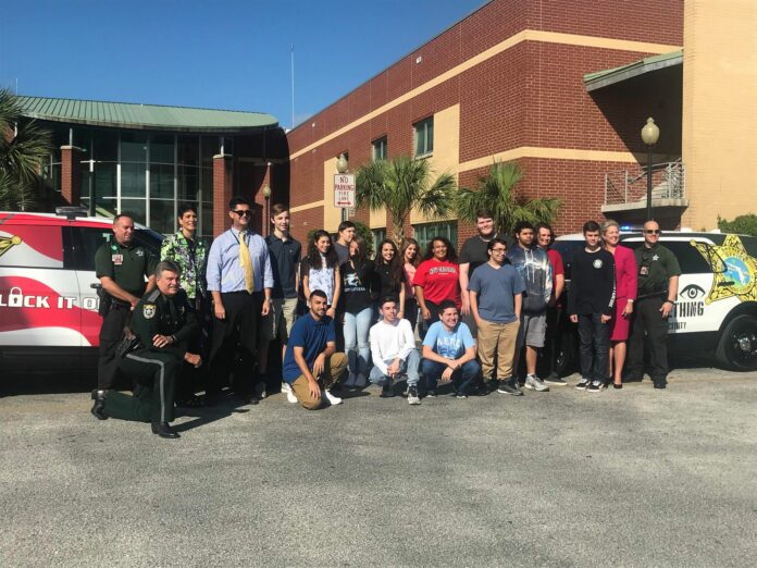 Nature Coast Tech's Graphics Arts students with both cars