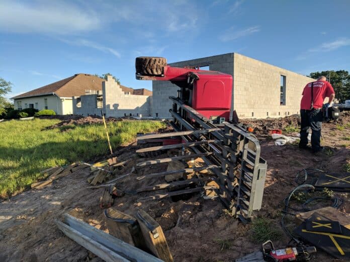 Forklift topples and traps construction worker