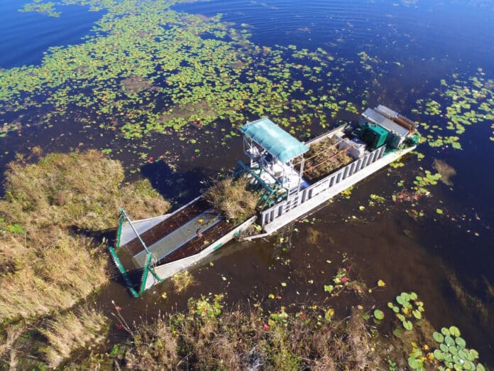 Harvester used to remove tussock from Hunters Lake.