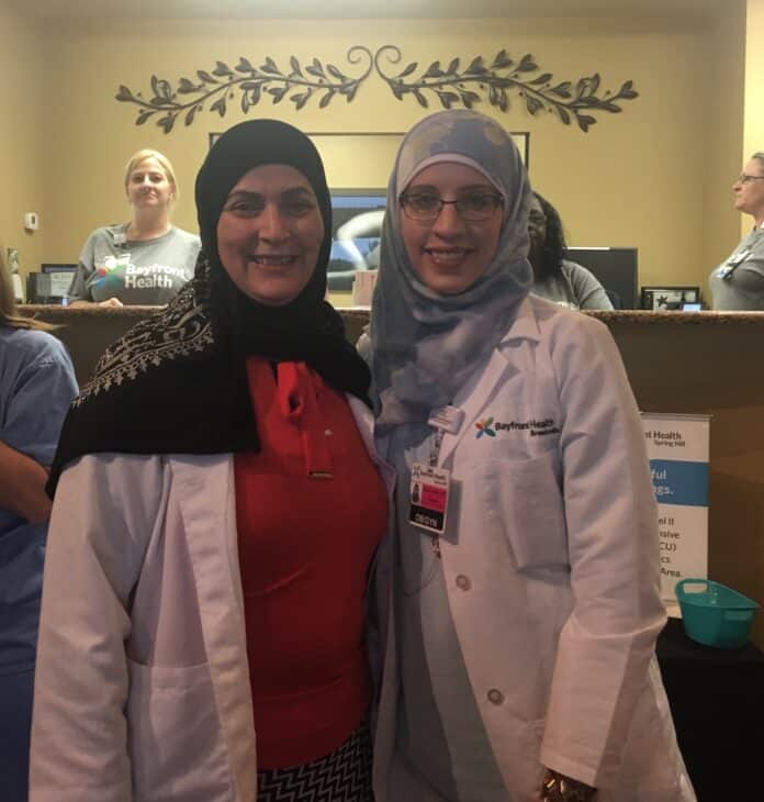 Dr. Amal Awwad, and Dr. Najat Al-Sherri, welcome visitors to the Open House.