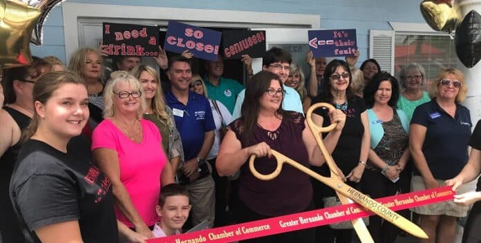 Owner Kristi Cheesman cuts the ribbon formally joining the Greater Hernando Chamber of Commerce