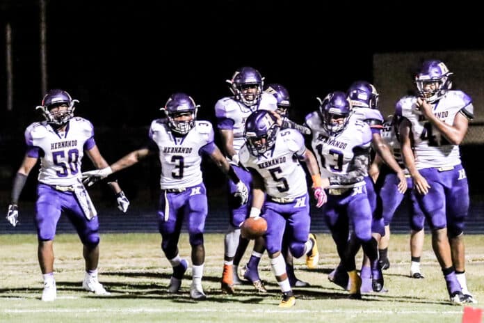 Number 5 Jordan Williams and teammates celebrate his interception in a match against Fivay.