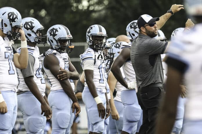 NCT players watch and learn from Coach Cory Johns before the game on Friday night against rival Springstead.