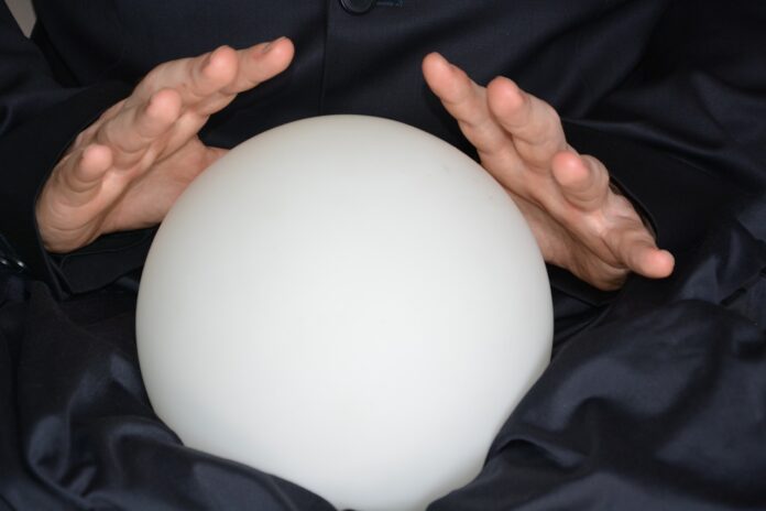 Photo of hands over a crystal ball