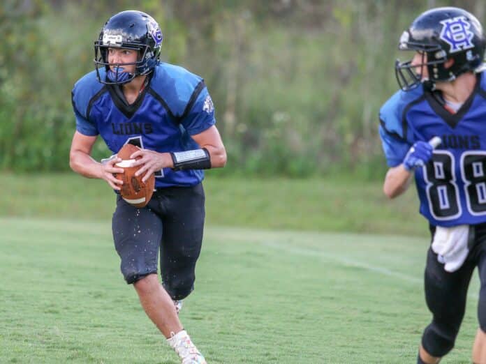 Lions Evan Klukowski looks for an open receiver during their home game against Donahue Catholic Friday Sept. 28