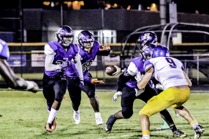 Hernando QB Boston Tafelski hands off to 26 Israel Fields 