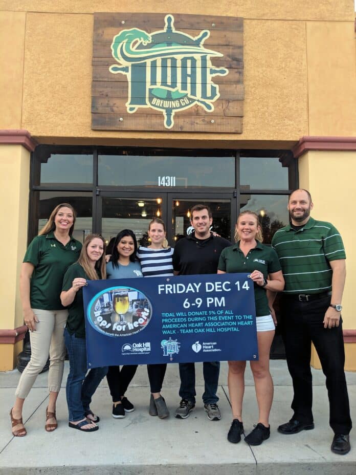 2018 Hops for Hearts Team: Members of Team Oak Hill pose with the owners of Tidal Brewing Company to promote their fundraiser. Left to right: Kristi Fuller, HR Coordinator; Stephanie Kindberg, Plant Ops Administrative Assistant; Melissa Dampier, Tidal Brewing Co. Manager; Maxine and Dave Peitzman, Tidal Brewing Co. Owners; Heather Bemis, HR Business Partner; Darin Wiedmer, Director of Materials.   