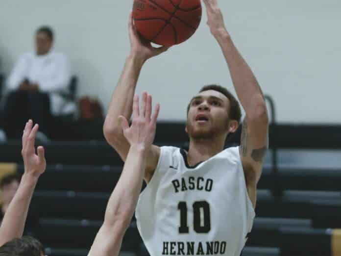 Daniel Buchanan-Derice attempts a layup as FSCJ’s Noah Lippy tries to block. Buchanan-Derice put eight points on the board for PHSC