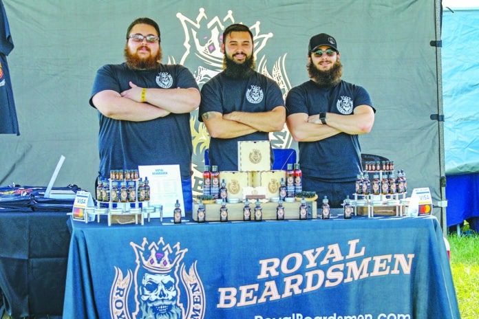 Garrett Homan, Shan McQuown and Thomas Maynard set up at a local festival over the Veterans Day weekend.