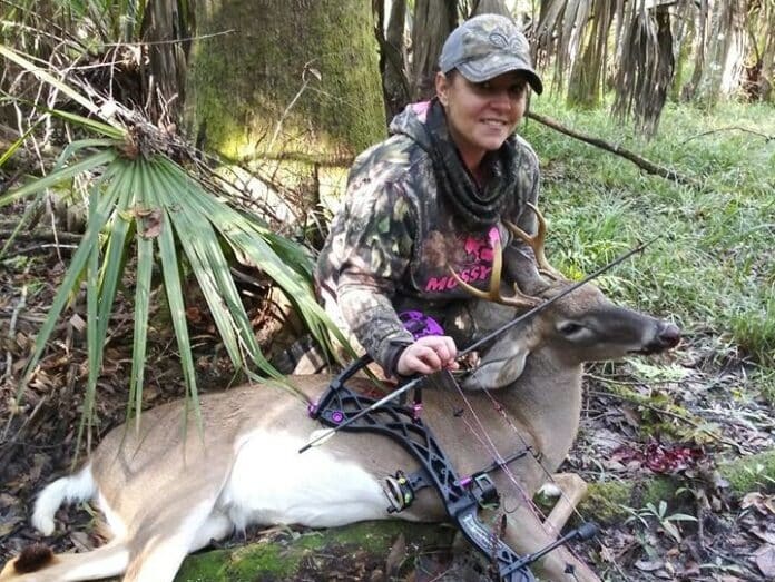 Shanna Marie Wofford with a beauty of a young rutting buck who came by her stand